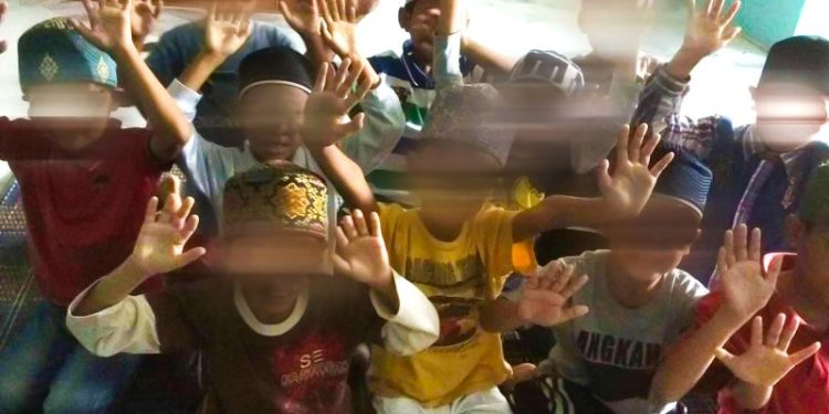 In public, they ran a successful global business. In private, police allege they abused hundreds of children